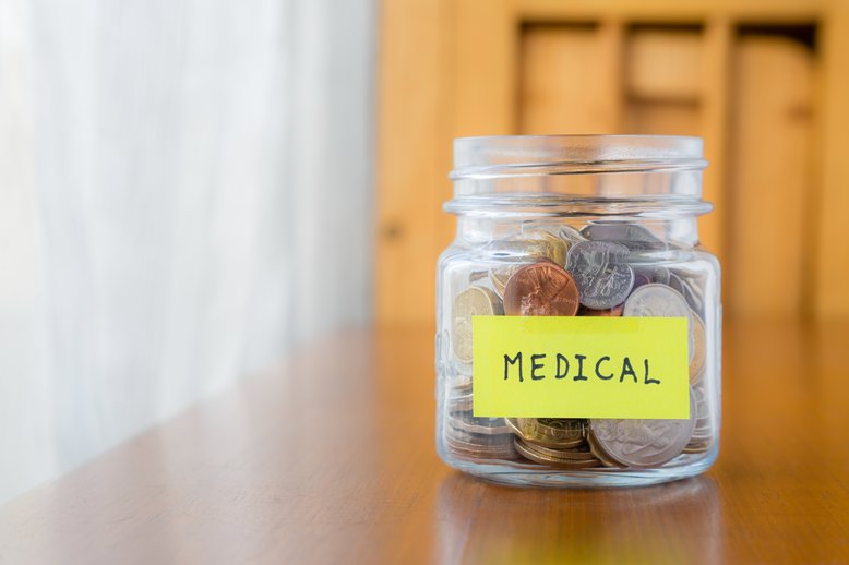 Coin jar with sticker that says "medical" [Image by creator vinnstock from AdobeStock]